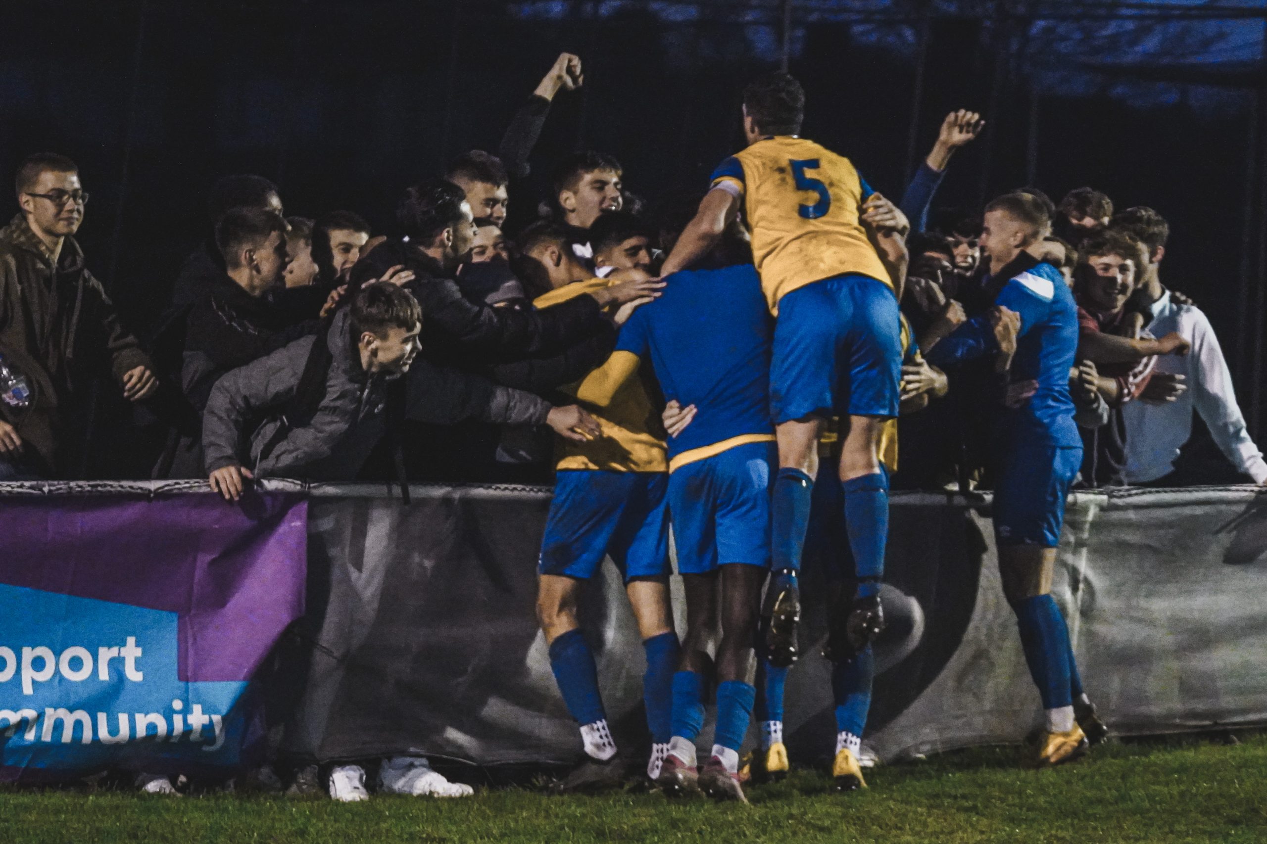 Eastbourne Town players celebrate with supporters after beating Bexhill United.