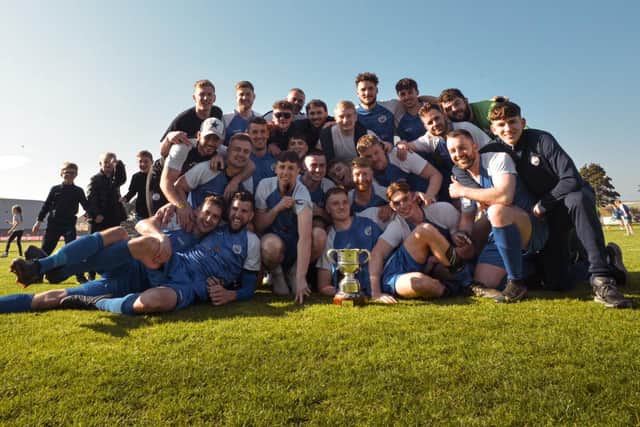 Shoreham FC squad celebrating winning division one title and promotion in 2022/23.